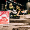 Bicycle Firefighters Playing Cards Deck on a cement floor inside of a fire station. Fire gear can be seen blurred in the background.