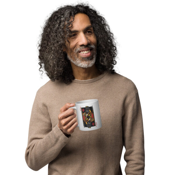 Man holding a mug with the Jack of Diamonds firefighter card on it. Mug is white.